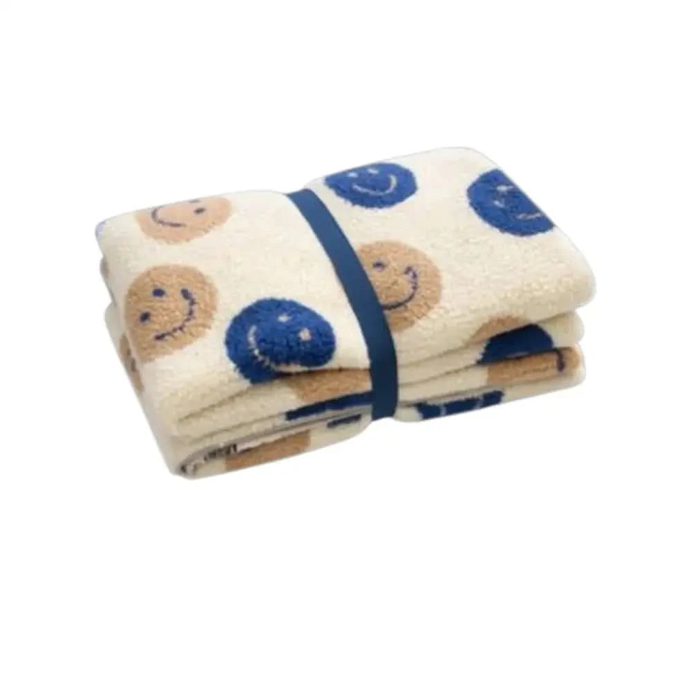 Eine weich cremefarbene hundedecke smiley mit flauschiger textur und fröhlichen gesichtern kompakt faltbar