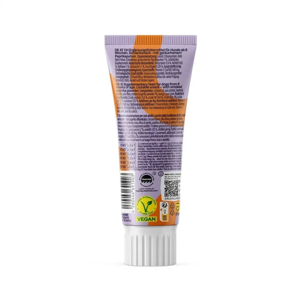 A tube of orange and white vegdog lever wurst dog supplement with a purple cap labeled vegan showing ingredient info