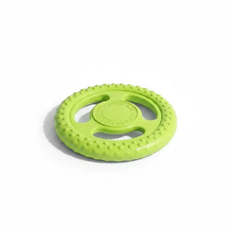Hellgrünes, strukturiertes gummispielzeug in lenkradform als kiwi walker dog disc frisbee robust und langlebig