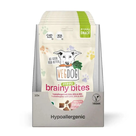 A package of vegdog puppy brainy bites hypoallergen hundesnacks with white green design and dog holding carrot