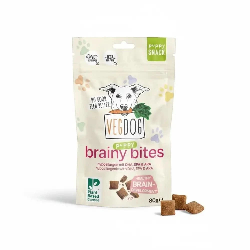 A bag of vegdog puppy brainy brainy bites with a playful dog illustration and brown square puppy brainy bites scattered