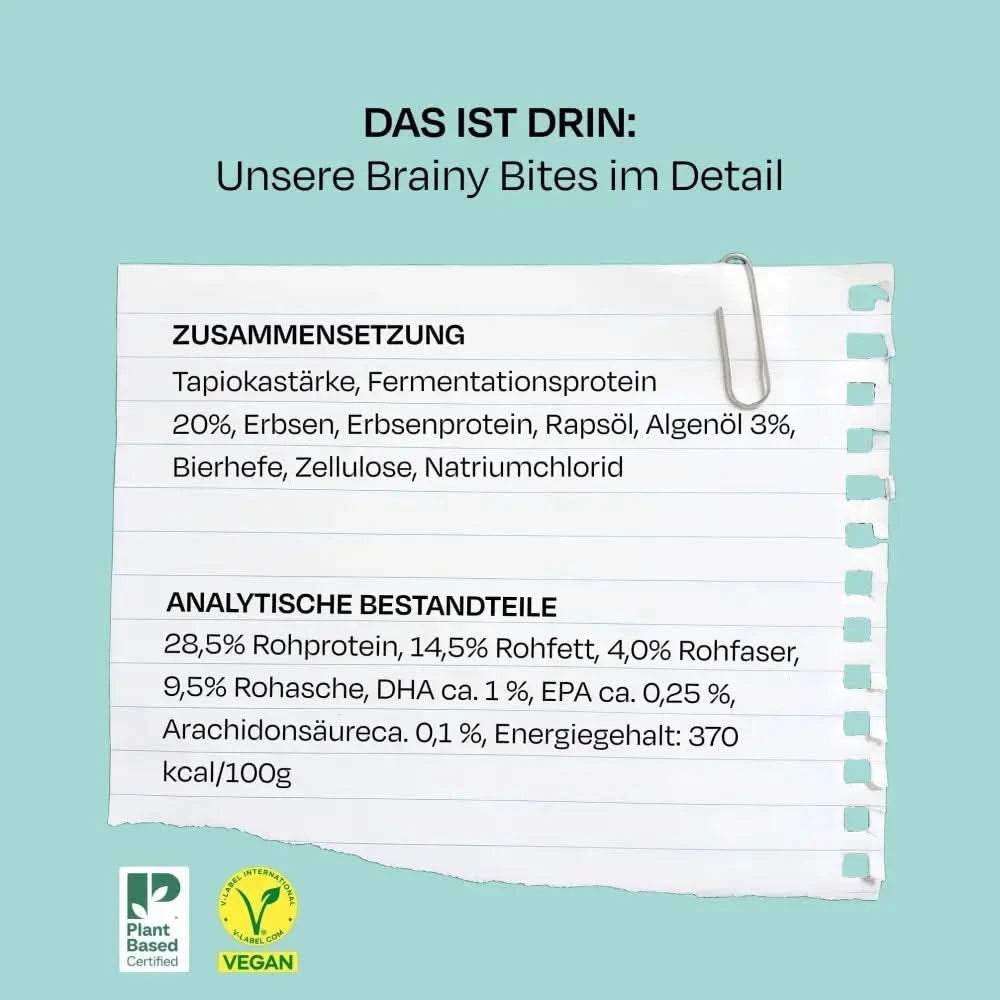 Weißes papier mit abgerissenen kanten und silbernem metallklammer für vegdog puppy brainy bites hundesnacks